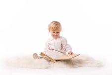 Cute Baby Sitting And Watching A Book Royalty Free Stock Photography