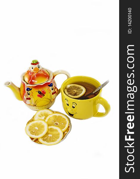 Funny kettle and a cup of tea with lemon on a white background. Funny kettle and a cup of tea with lemon on a white background