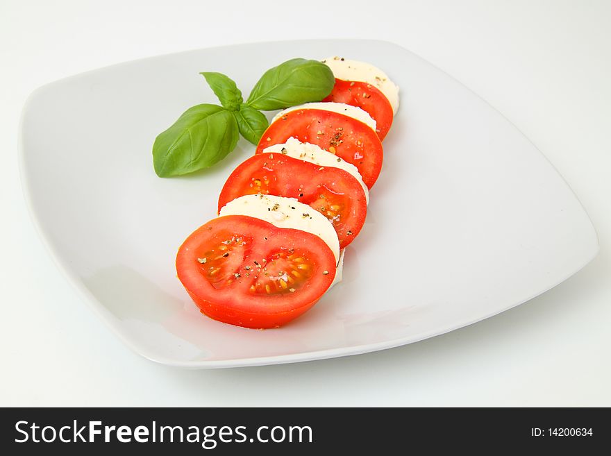 Tomato and mozzarella on a plate. Tomato and mozzarella on a plate