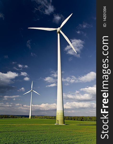 Windmills against a blue sky and clouds, alternative energy source