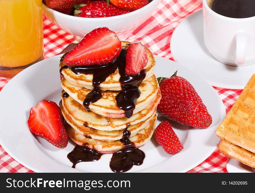 Breakfast with pancakes and fresh strawberry