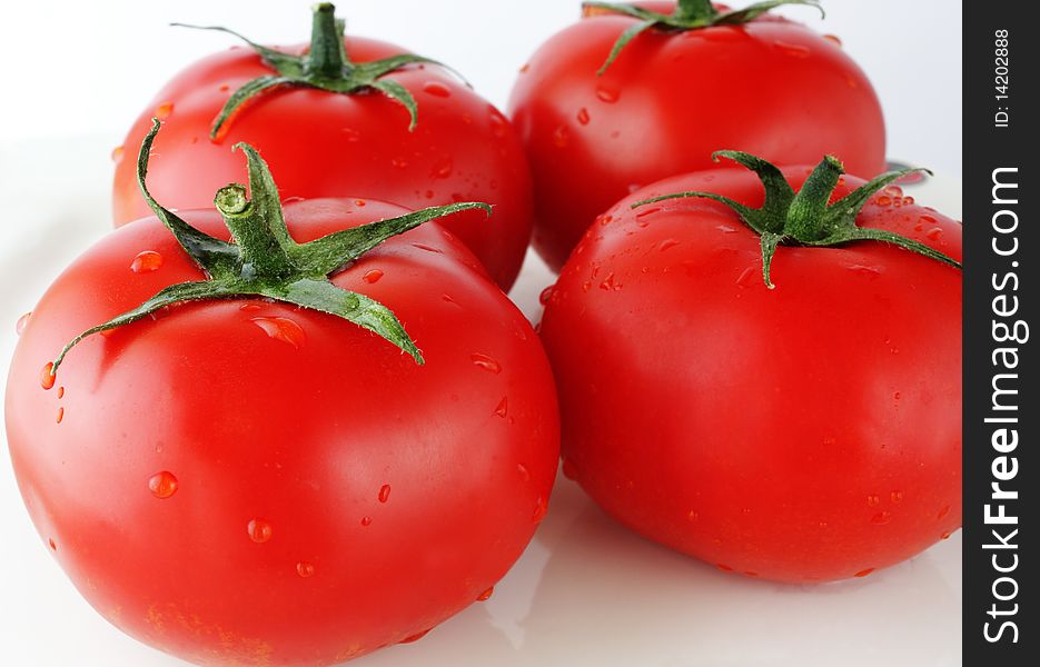 Close up image of four ripe tomatoes