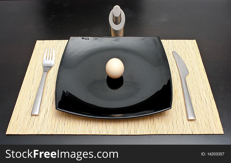 Dinner egg in a black plate