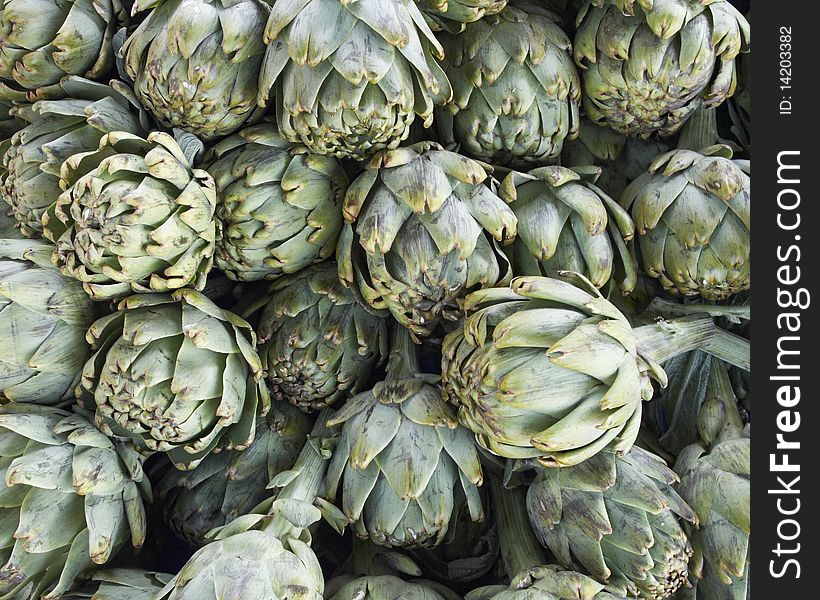 Fresh artichokes in local market background