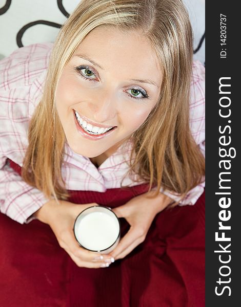 Woman in pajama in bed with glass of milk. Woman in pajama in bed with glass of milk