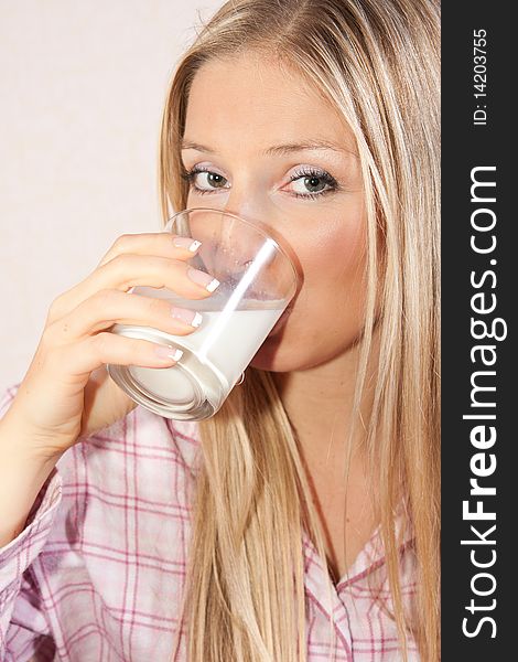 Woman in bed with glass of milk