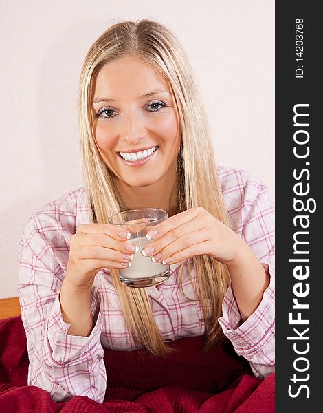 Woman In Bed With Glass Of Milk