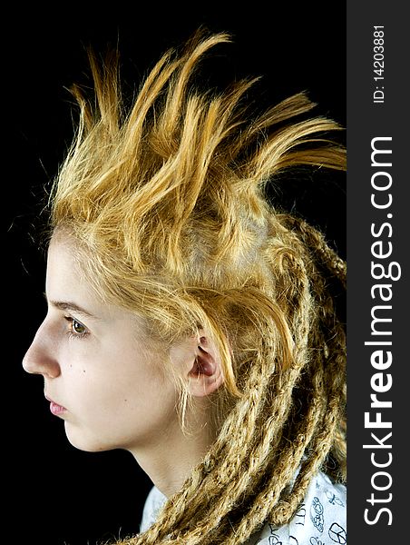 Young girl with a strange hairdo on a black background