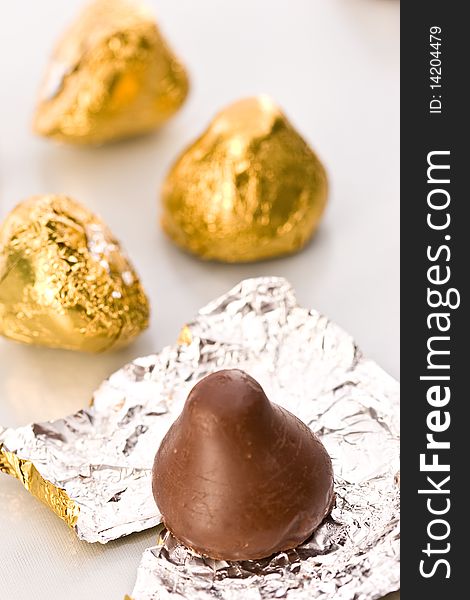 Sweet, chocolate candy on the golden foil