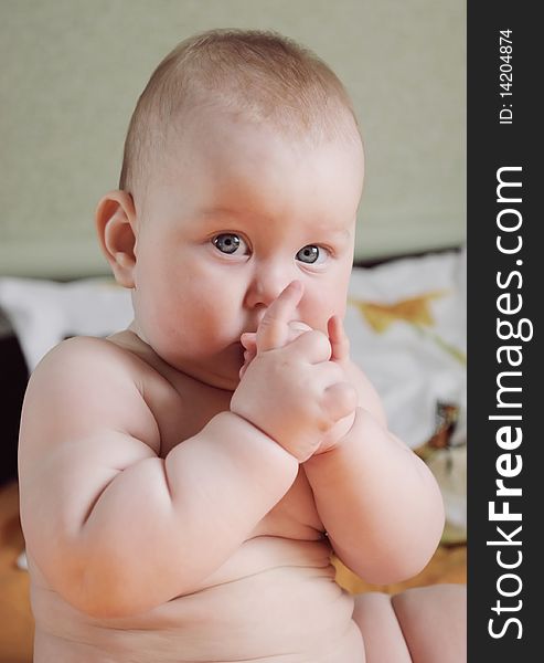 Portrait of beautiful little boy, looking with curiosity large blue eyes on the world