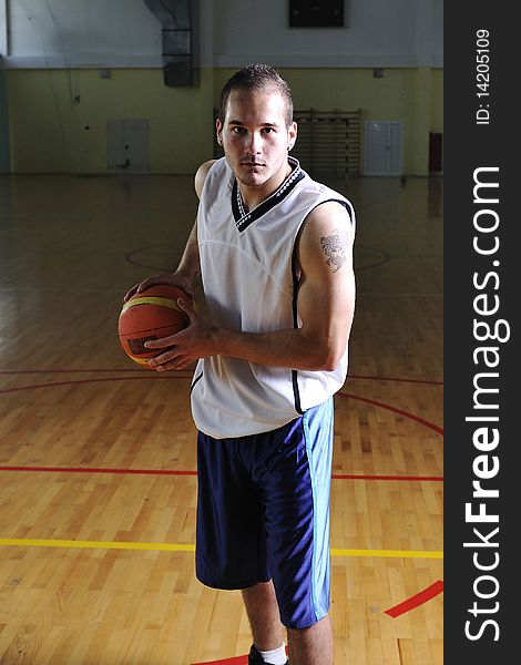 One healthy young man play basketball game in school gym indoor relax. One healthy young man play basketball game in school gym indoor relax