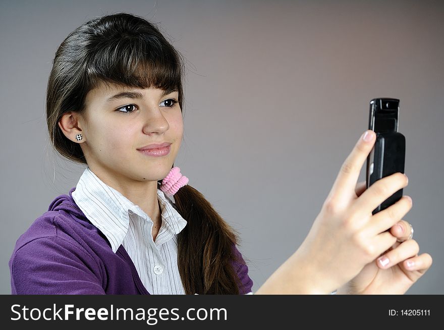White teen creating photos with her phone. White teen creating photos with her phone