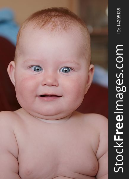 Portrait of beautiful little boy, looking with curiosity large blue eyes on the world