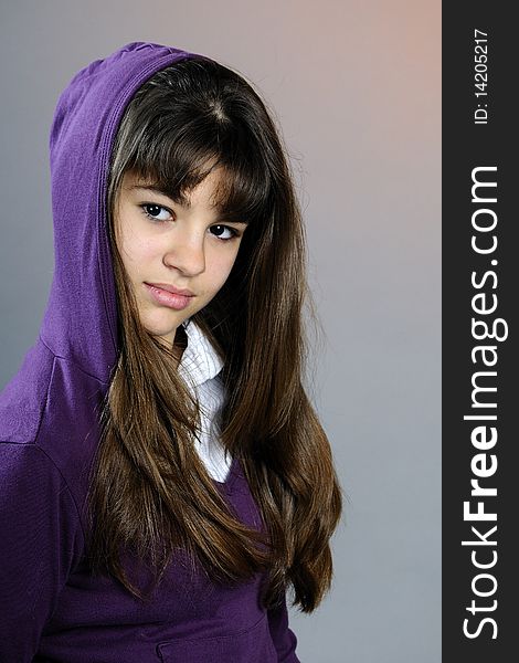 Beautiful teen posing in studio with purple blouse. Beautiful teen posing in studio with purple blouse