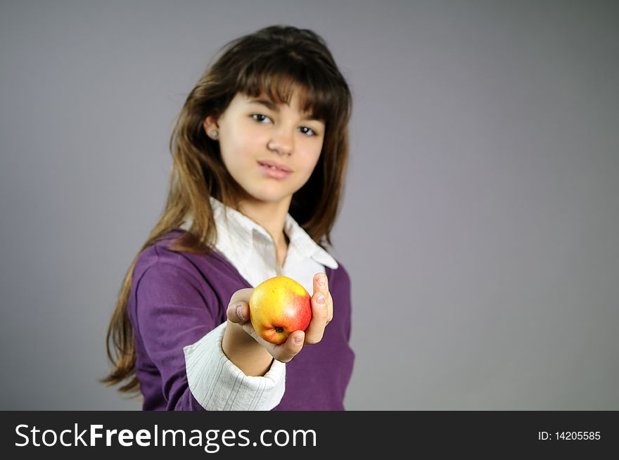 Beautiful teenager giving healthy fruit to her friends. Beautiful teenager giving healthy fruit to her friends