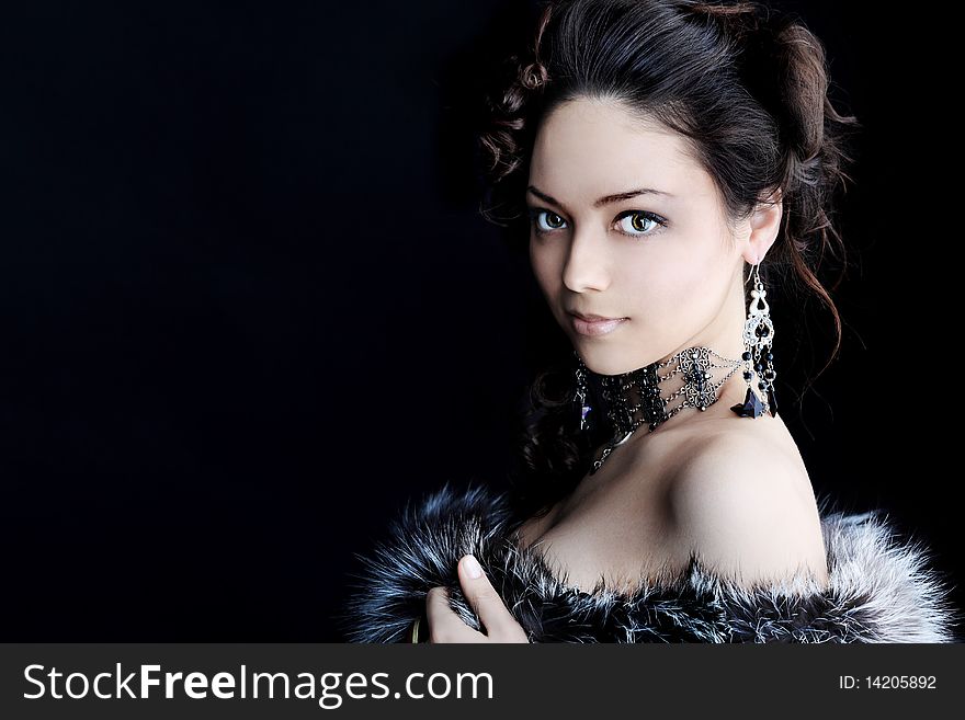 Portrait of a beautiful woman over black background. Portrait of a beautiful woman over black background..