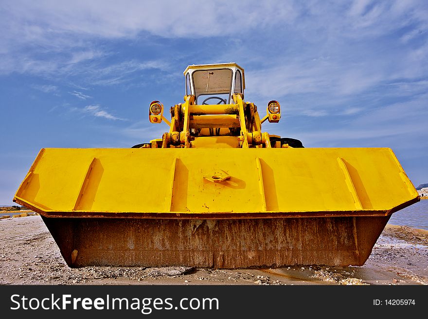 A yellow bulldozer in a construction site