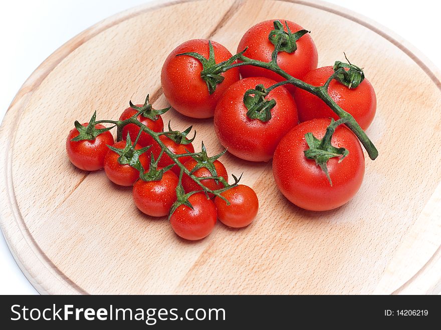 Fresh tomatoes on a wooden worktop. Fresh tomatoes on a wooden worktop