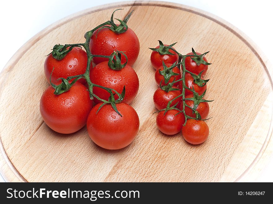 Fresh tomatoes on a wooden worktop. Fresh tomatoes on a wooden worktop