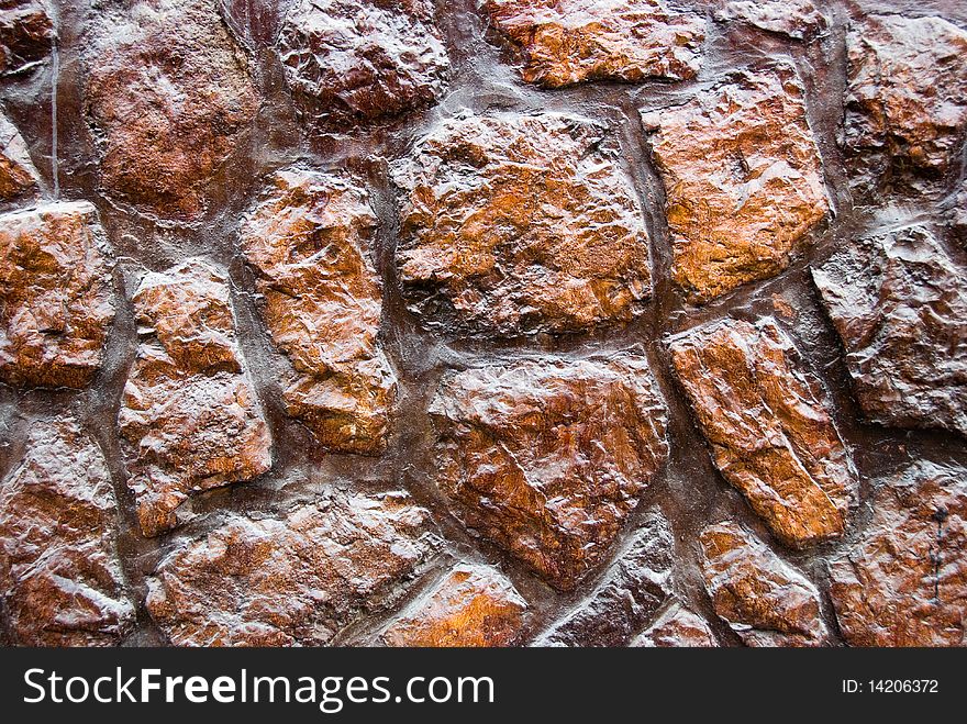Close-up of a wall made of red rocks and mortar. Useful for backgrounds. Close-up of a wall made of red rocks and mortar. Useful for backgrounds