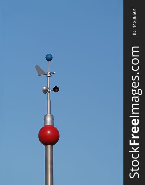 Colorful weather station instruments measuring wind speed and direction. Colorful weather station instruments measuring wind speed and direction