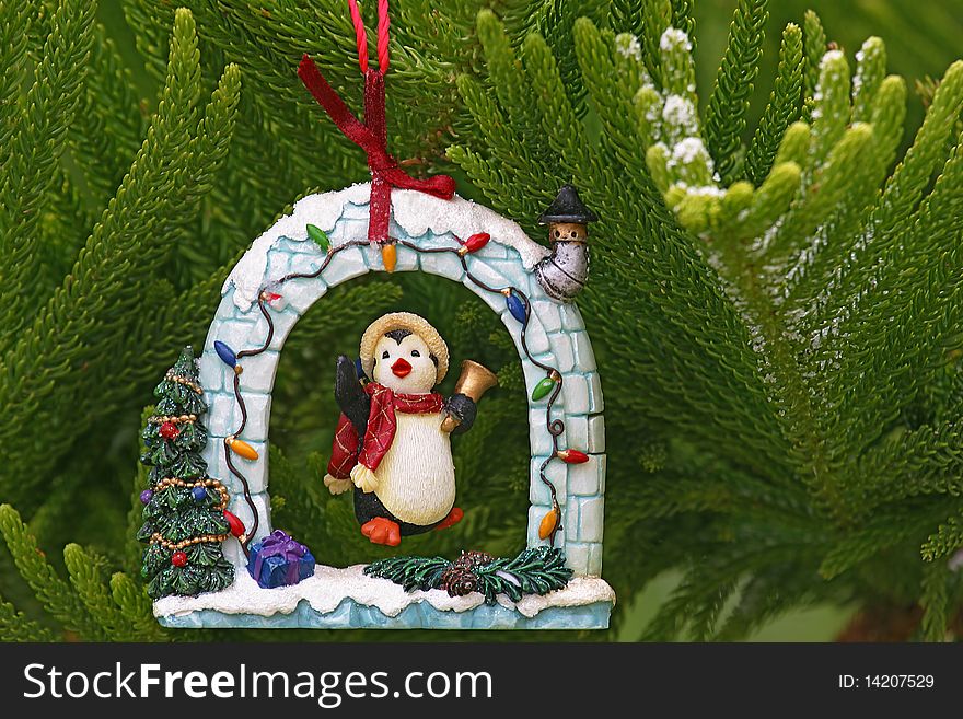 Penguin ringing bell in Christmas tree decoration