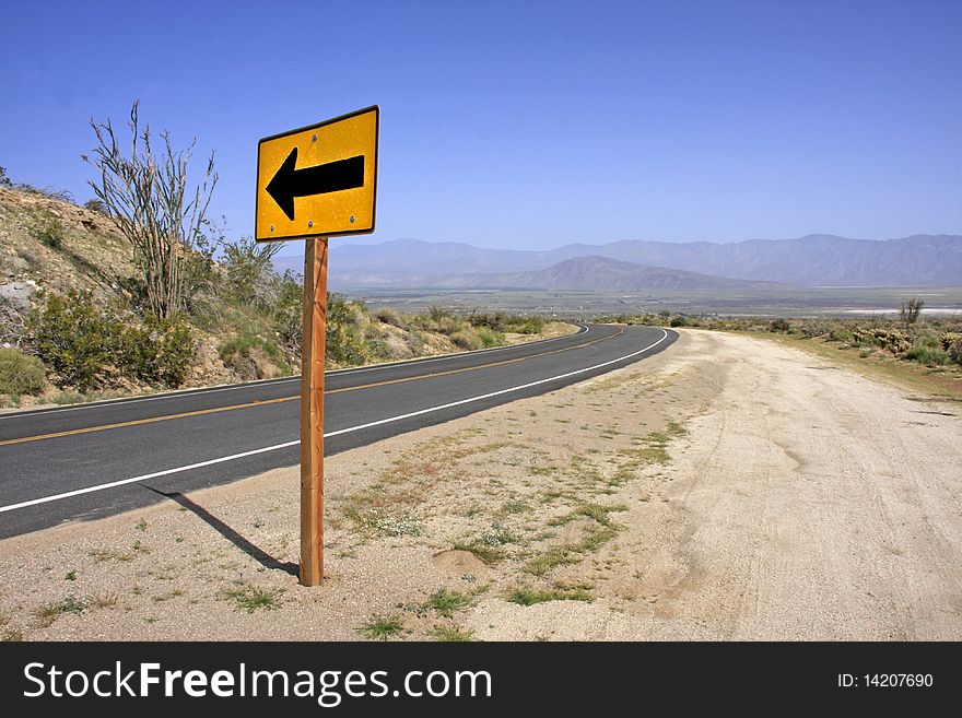 Left Turn sign on a desert road