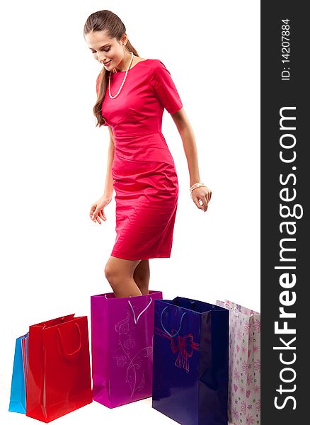 Young beautiful woman  in red dress with color packages. Young beautiful woman  in red dress with color packages