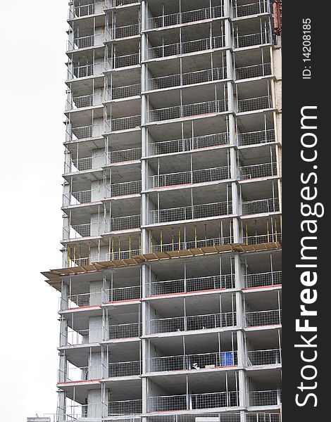 Unfinished / under construction  apartment building against a white sky