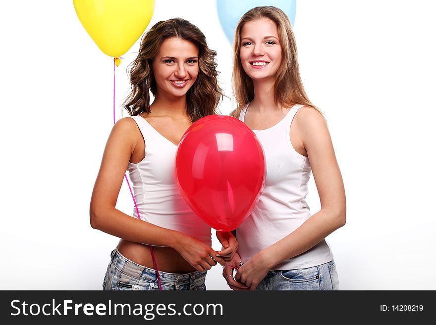 Two beautiful young girlfriends with color balloons. Two beautiful young girlfriends with color balloons