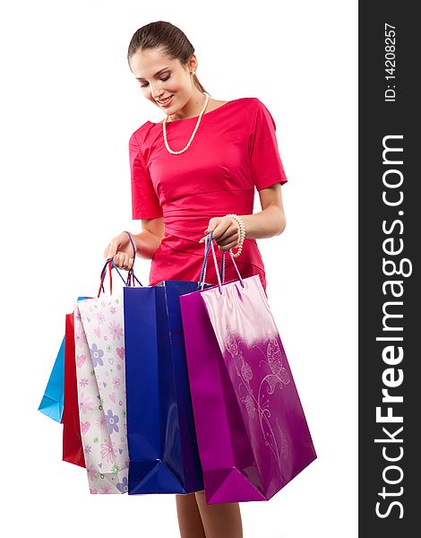 Young beautiful woman  in red dress with color packages. Young beautiful woman  in red dress with color packages