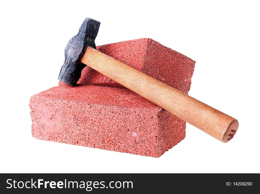 Building materials and tools: a hammer with a brick from red clay.