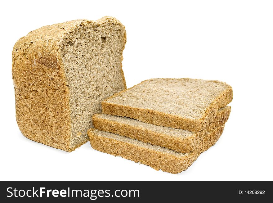 Freshly baked loaf of bread and slices of bread isolated on white background. Freshly baked loaf of bread and slices of bread isolated on white background.