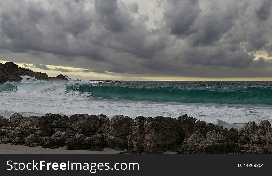 Landscape view of breaking wave on a stormy morning. Landscape view of breaking wave on a stormy morning.