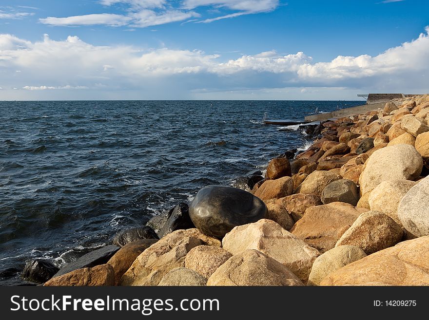 Seaside with big stones on the coast and with clouds in the sky. Seaside with big stones on the coast and with clouds in the sky