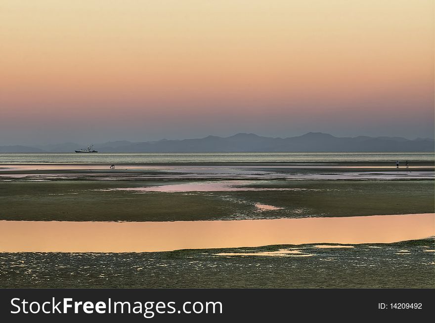 A Sunset near Marahau and Abel Tasman National Park on the South Island of New Zealand. A Sunset near Marahau and Abel Tasman National Park on the South Island of New Zealand