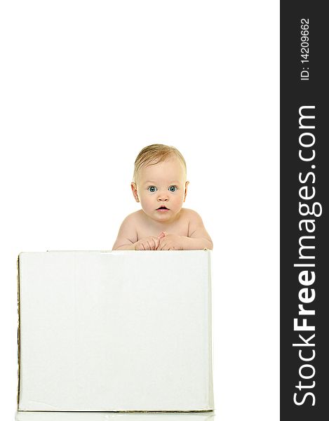 Eight month baby holds on to the white box. Eight month baby holds on to the white box