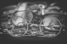 Retro Round Spectacles Close Up, Monochrome Effect. Heap Of Scratched And Broken Eyeglasses. Repairing And Replacing Old Royalty Free Stock Photos
