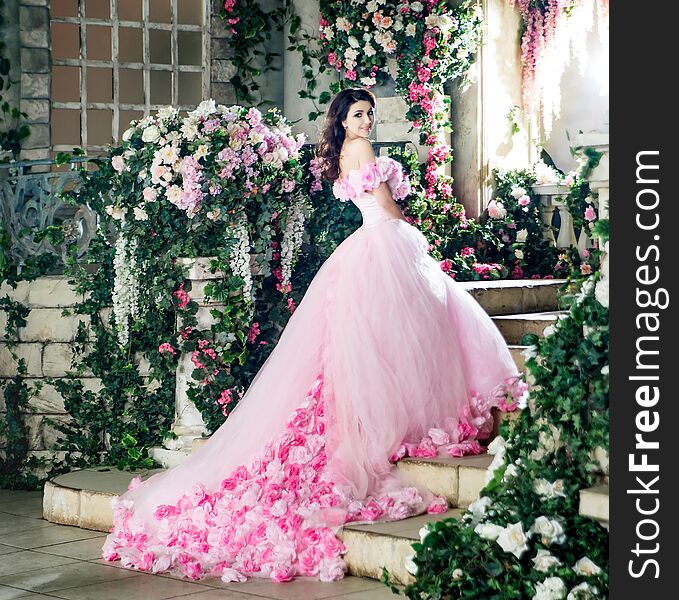 Attractive fashion model in blossom floral garden.