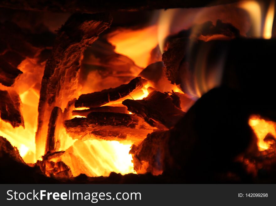 Burning firewood in the stove for cooking,embers,glowing coals.