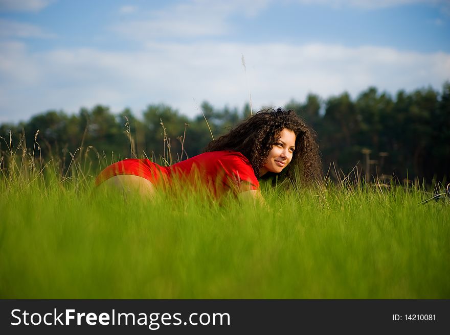 Very pretty woman in red on the grass. Very pretty woman in red on the grass