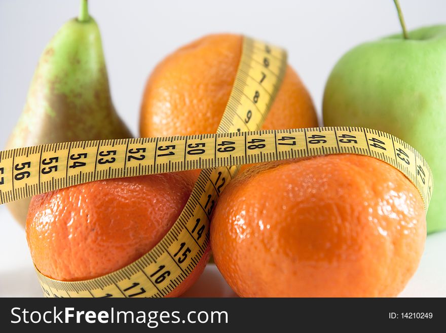 Fruits and measuring tape. Diet concept illustration. Fruits and measuring tape. Diet concept illustration