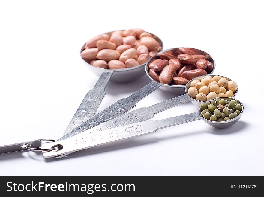 Peanuts, red bean, soybean, and green bean in a unique measure spoon. Peanuts, red bean, soybean, and green bean in a unique measure spoon