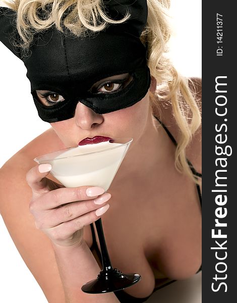 Portrait of the blond model wearing black cat, licking - drinking milk from the martini glass. Portrait of the blond model wearing black cat, licking - drinking milk from the martini glass