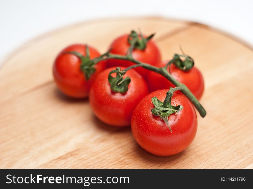 Fresh tomatoes on a wooden worktop