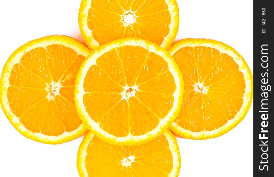 Five overlapping slices of orange in the form of a cross on a white background. Five overlapping slices of orange in the form of a cross on a white background.