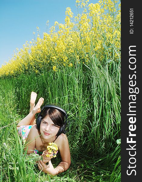 A beautiful young girl listening music in nature. A beautiful young girl listening music in nature