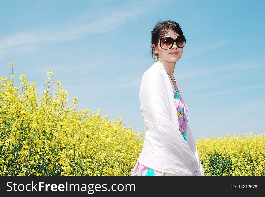 Young beautiful girl enjoying a sunny day on canola field. Young beautiful girl enjoying a sunny day on canola field