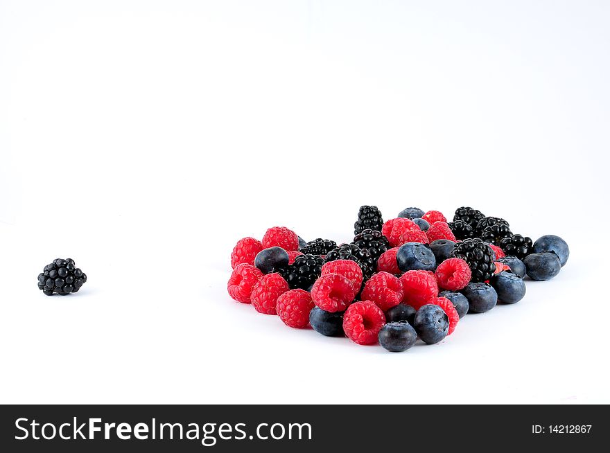 Berries on white background with a single blackberry on the side. Berries on white background with a single blackberry on the side