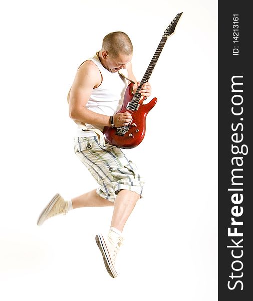 Passionate guitarist jumps in the air over white